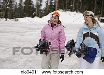 Stock Photography - young women carrying 
snowboards. fotosearch 
- search stock 
photos, pictures, 
images, and photo 
clipart