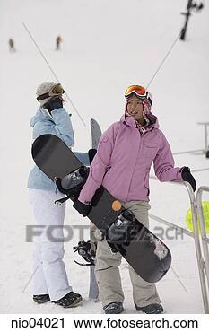 Stock Photography - young women holding 
snowboards. fotosearch 
- search stock 
photos, pictures, 
images, and photo 
clipart