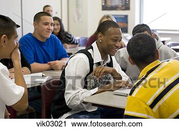 Stock Photography - african and hispanic 
teenagers working 
on laptop in classroom. 
fotosearch - search 
stock photos, 
pictures, images, 
and photo clipart