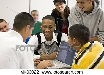 Stock Photo - african and hispanic 
teenagers working 
on laptop in classroom. 
fotosearch - search 
stock photos, 
pictures, images, 
and photo clipart