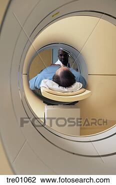 Stock Photo - african male doctor 
supervising patient 
in scanner. fotosearch 
- search stock 
photos, pictures, 
images, and photo 
clipart