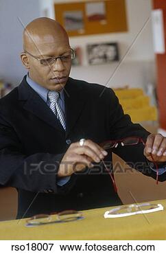 Picture - african man shopping 
for eyeglasses. 
fotosearch - search 
stock photos, 
pictures, images, 
and photo clipart
