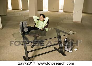 Picture - asian businessman 
relaxing in empty 
office. fotosearch 
- search stock 
photos, pictures, 
images, and photo 
clipart