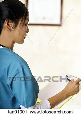 Stock Photography - asian female nurse 
writing on clipboard. 
fotosearch - search 
stock photos, 
pictures, images, 
and photo clipart