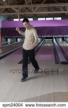 Stock Photo - asian man celebrating 
after bowling 
a strike. fotosearch 
- search stock 
photos, pictures, 
images, and photo 
clipart