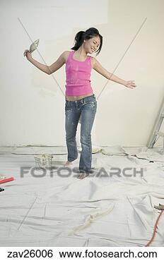 Stock Photo - asian woman dancing 
while painting 
unfinished room. 
fotosearch - search 
stock photos, 
pictures, images, 
and photo clipart