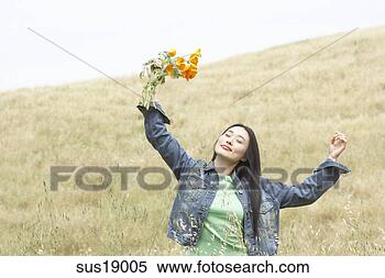 Stock Image - asian woman holding 
bunch of flowers. 
fotosearch - search 
stock photos, 
pictures, images, 
and photo clipart