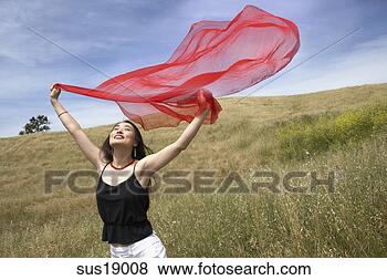 Stock Photo - asian woman running 
in field with 
scarf. fotosearch 
- search stock 
photos, pictures, 
images, and photo 
clipart
