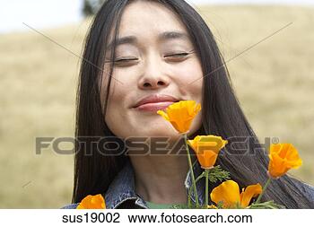 Stock Photo - asian woman smelling 
flowers. fotosearch 
- search stock 
photos, pictures, 
images, and photo 
clipart