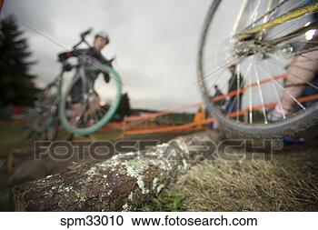 Stock Photography - athlete carrying 
bicycle during 
race. fotosearch 
- search stock 
photos, pictures, 
images, and photo 
clipart