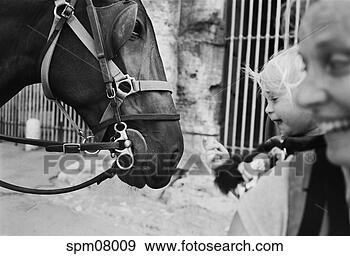 Stock Photograph - baby touching 
horse's nose outside 
roman coliseum. 
fotosearch - search 
stock photos, 
pictures, images, 
and photo clipart