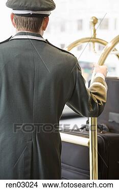 Stock Photo - bellhop with hand 
on luggage cart. 
fotosearch - search 
stock photos, 
pictures, images, 
and photo clipart