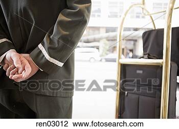 Stock Photo - bellhop with hands 
behind back. fotosearch 
- search stock 
photos, pictures, 
images, and photo 
clipart