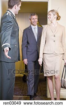 Stock Photograph - bellhop welcoming 
couple. fotosearch 
- search stock 
photos, pictures, 
images, and photo 
clipart