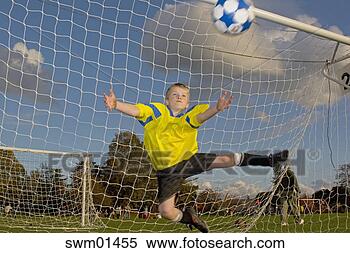 Stock Image - boy goalie catching 
soccer ball. fotosearch 
- search stock 
photos, pictures, 
images, and photo 
clipart