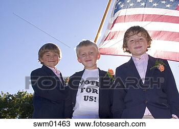 Stock Photo - boy wearing ‘vote 
for us' t-shirt 
and carrying american 
flag. fotosearch 
- search stock 
photos, pictures, 
images, and photo 
clipart