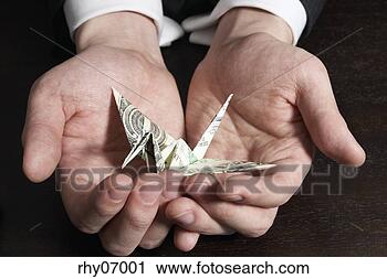 Stock Photography - businessman holding 
origami in palm. 
fotosearch - search 
stock photos, 
pictures, images, 
and photo clipart
