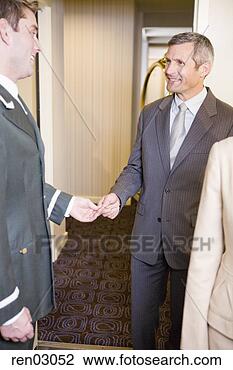Stock Photo - businessman tipping 
bellhop. fotosearch 
- search stock 
photos, pictures, 
images, and photo 
clipart