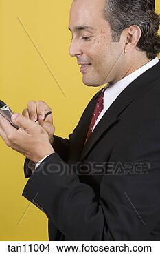 Stock Photo - businessman using 
a electronic organizer. 
fotosearch - search 
stock photos, 
pictures, images, 
and photo clipart