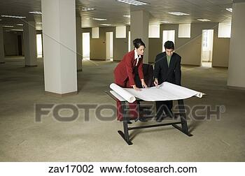 Stock Photo - businesspeople 
looking at blueprints. 
fotosearch - search 
stock photos, 
pictures, images, 
and photo clipart