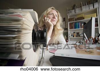 Stock Photo - businesswoman 
daydreaming at 
her desk. fotosearch 
- search stock 
photos, pictures, 
images, and photo 
clipart