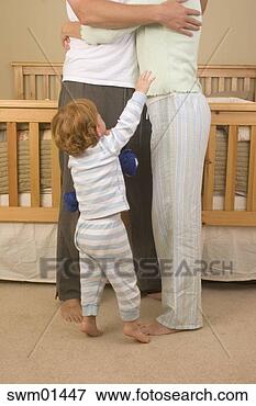 Picture - child reaching 
up to hugging 
parents. fotosearch 
- search stock 
photos, pictures, 
images, and photo 
clipart