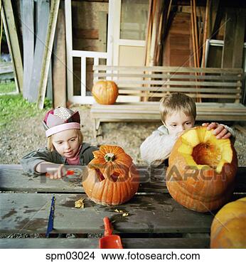 Stock Photo - children carving 
pumpkins for halloween. 
fotosearch - search 
stock photos, 
pictures, images, 
and photo clipart