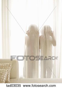 Stock Image - children hiding 
behind sheer curtains. 
fotosearch - search 
stock photos, 
pictures, images, 
and photo clipart