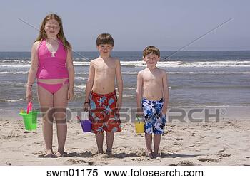 Stock Image - children holding 
buckets on beach. 
fotosearch - search 
stock photos, 
pictures, images, 
and photo clipart