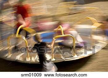 Stock Photograph - children turning 
merry-go-round 
on playground. 
fotosearch - search 
stock photos, 
pictures, images, 
and photo clipart