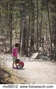 Stock Photo - children tying 
shoes on gravel 
road. fotosearch 
- search stock 
photos, pictures, 
images, and photo 
clipart