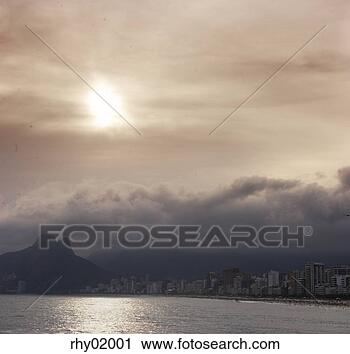 Stock Photography - city by mountain 
overcast by clouds, 
rio de janeiro. 
fotosearch - search 
stock photos, 
pictures, images, 
and photo clipart