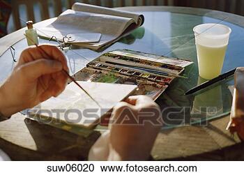 Stock Photography - close-up of person's 
hands painting 
with watercolors. 
fotosearch - search 
stock photos, 
pictures, images, 
and photo clipart