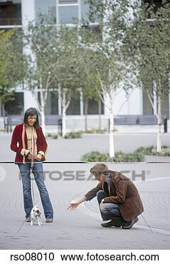 Stock Photography - couple playing 
with small dog. 
fotosearch - search 
stock photos, 
pictures, images, 
and photo clipart