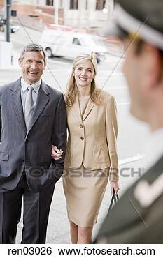 Stock Photo - couple smiling 
at bellhop. fotosearch 
- search stock 
photos, pictures, 
images, and photo 
clipart