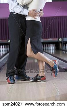 Picture - couple wearing 
bowling shoes 
hugging in bowling 
alley. fotosearch 
- search stock 
photos, pictures, 
images, and photo 
clipart