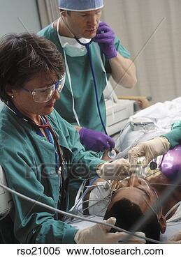 Stock Image - doctors preparing 
patient for surgery. 
fotosearch - search 
stock photos, 
pictures, images, 
and photo clipart