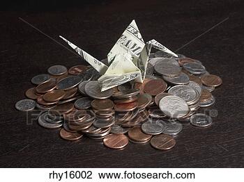 Stock Photo - dollar bill crane 
on pile of change. 
fotosearch - search 
stock photos, 
pictures, images, 
and photo clipart