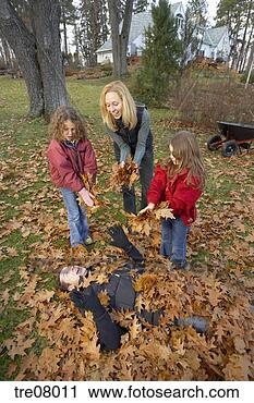 Stock Photography - family playing 
in autumn leaves. 
fotosearch - search 
stock photos, 
pictures, images, 
and photo clipart