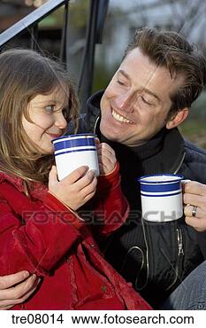 Stock Photo - father and daughter 
drinking from 
mugs. fotosearch 
- search stock 
photos, pictures, 
images, and photo 
clipart