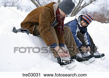 Stock Photography - father and son 
putting on ice 
skates. fotosearch 
- search stock 
photos, pictures, 
images, and photo 
clipart