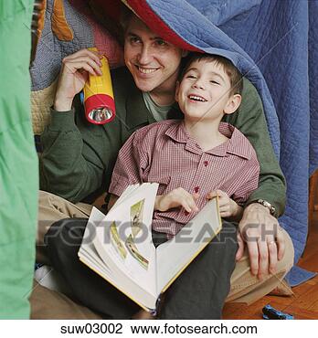 Stock Photo - father and son 
reading under 
blanket. fotosearch 
- search stock 
photos, pictures, 
images, and photo 
clipart