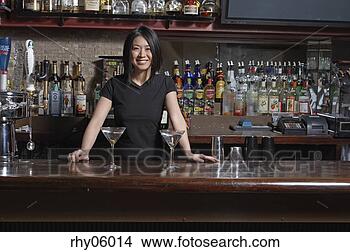 Stock Photo - female asian bartender 
serving martinis. 
fotosearch - search 
stock photos, 
pictures, images, 
and photo clipart