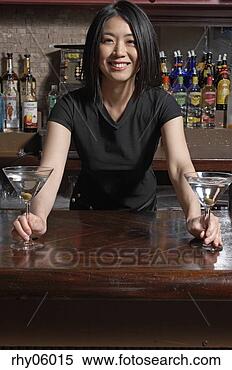 Stock Image - female asian bartender 
serving martinis. 
fotosearch - search 
stock photos, 
pictures, images, 
and photo clipart
