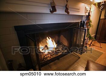 Stock Photography - fireplace with 
blazing logs. 
fotosearch - search 
stock photos, 
pictures, images, 
and photo clipart
