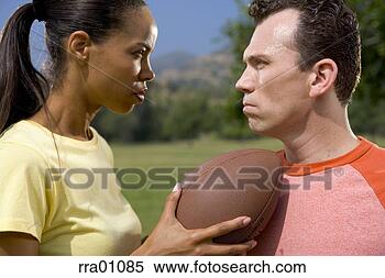 Stock Image - football opponents 
glaring at each 
other. fotosearch 
- search stock 
photos, pictures, 
images, and photo 
clipart