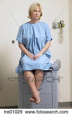 Stock Photograph - forlorn woman 
sitting on doctor's 
table. fotosearch 
- search stock 
photos, pictures, 
images, and photo 
clipart