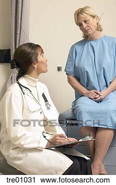 Stock Photography - forlorn woman 
talking to doctor. 
fotosearch - search 
stock photos, 
pictures, images, 
and photo clipart