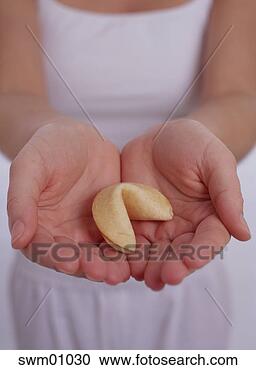 Stock Photography - girl holding out 
fortune cookie. 
fotosearch - search 
stock photos, 
pictures, images, 
and photo clipart