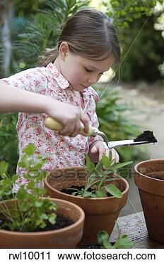 Stock Photography - girl potting plants. 
fotosearch - search 
stock photos, 
pictures, images, 
and photo clipart